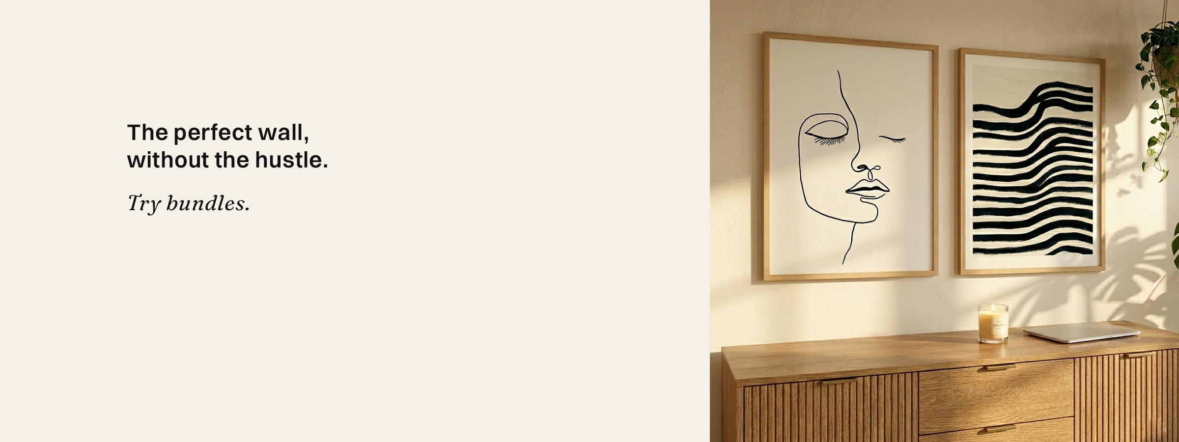Two framed artworks on a wall with a wooden console table below.